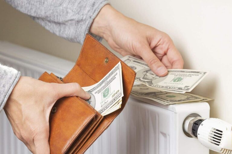 A closeup of hands counting money on an air conditining unit