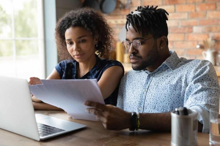 A couple looks over their AC warranty