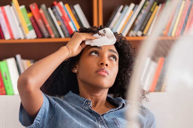 A women dabbing her forehead
