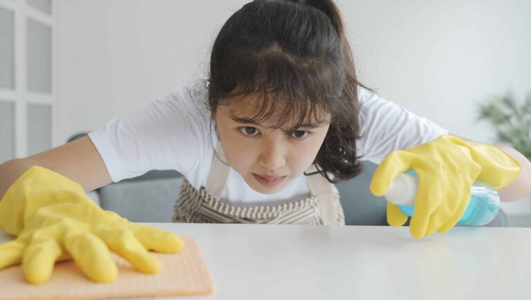 A woman cleaning her kitchen counter