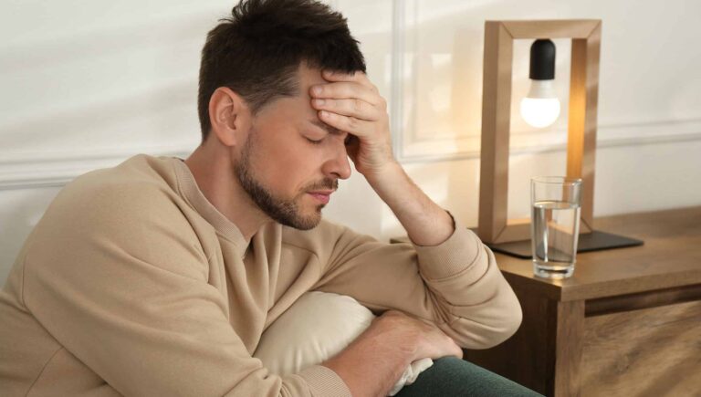 A man holding his head in pain