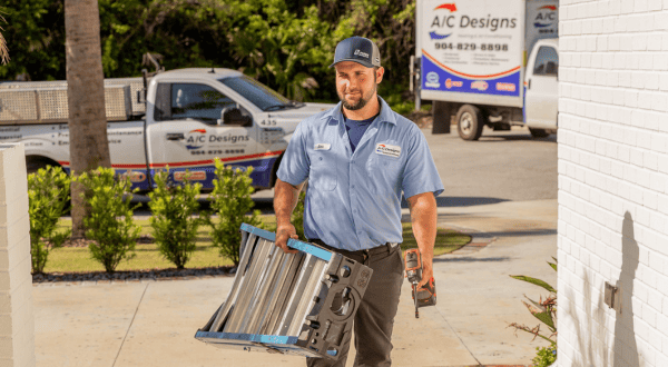 HVAC technician carrying a ladder