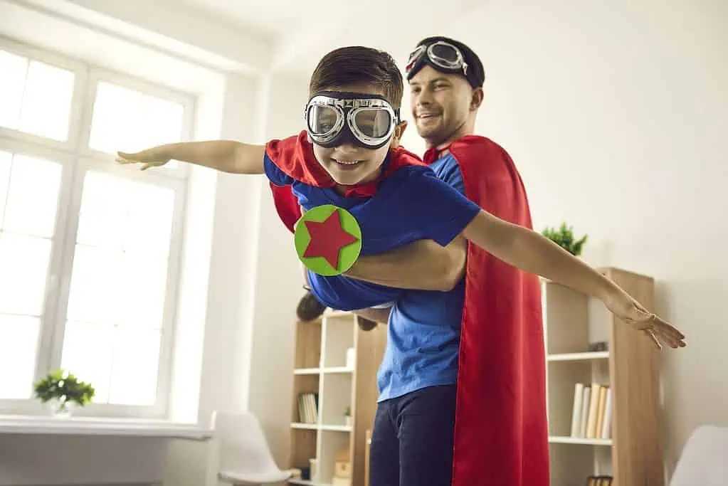 A father & son dresses as superheroes playing