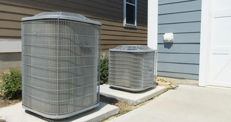 Two air conditioner compressor units attached to the residential house