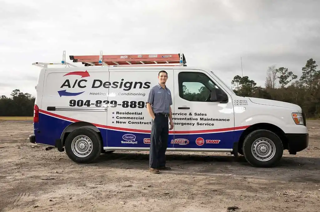HVAC technician stands by an AC Designs van