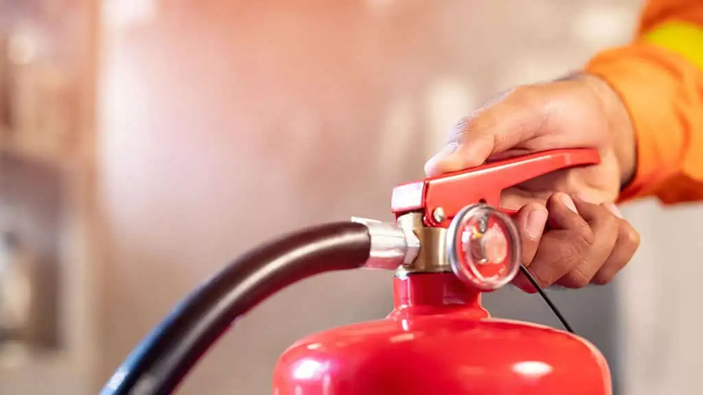 A person using a fire extinguisher