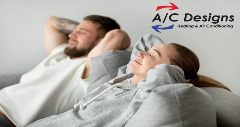Relaxed young couple resting on comfortable sofa together at home, happy woman smiling breathing fresh air leaning on soft cushion of new couch, man and woman enjoying nap relaxing or meditating